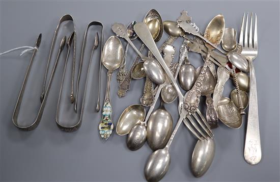 A collection of silver, continental white metal spoons including commemorative, two forks and three pairs of sugar tongs, etc.